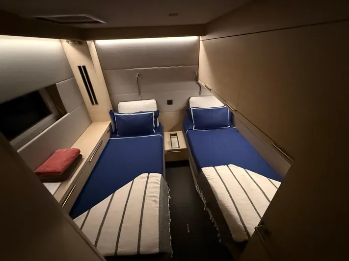 Jdmontt Yacht Photos Pics 2024 Lagoon 55 yacht cabin with twin beds, modern design, and ambient lighting.