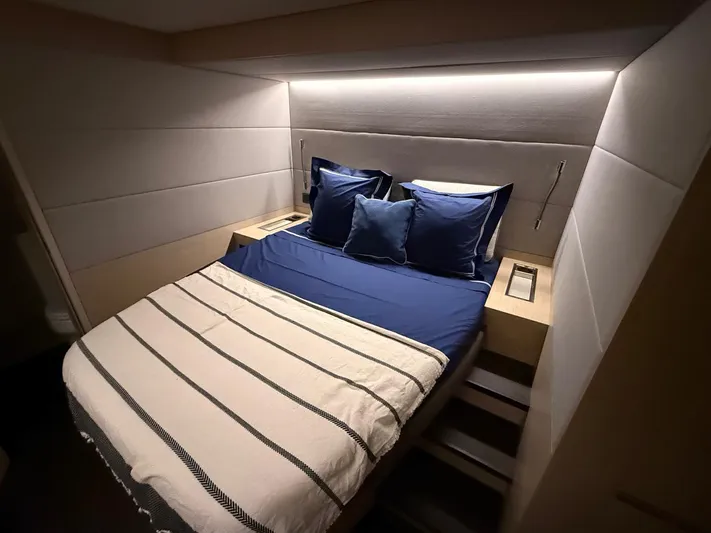 Jdmontt Yacht Photos Pics Luxurious bedroom interior of 2024 Lagoon 55 yacht with modern lighting and cozy bedding.