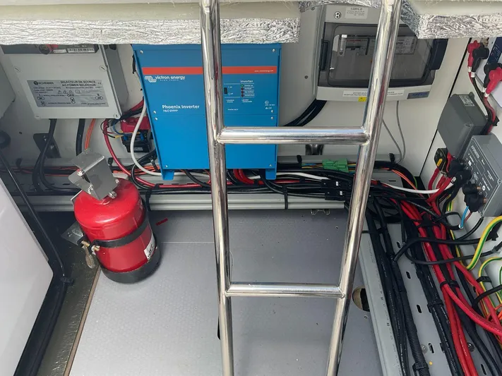 Jdmontt Yacht Photos Pics Engine room of 2024 Lagoon 55 yacht with fire extinguisher and electrical equipment.