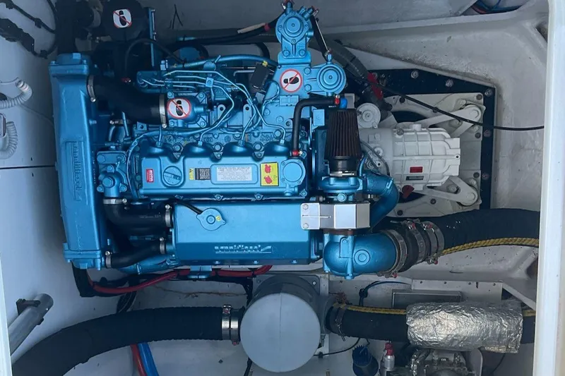 Jdmontt Yacht Photos Pics Engine compartment of a 2024 Lagoon 55 yacht, featuring a blue marine engine.
