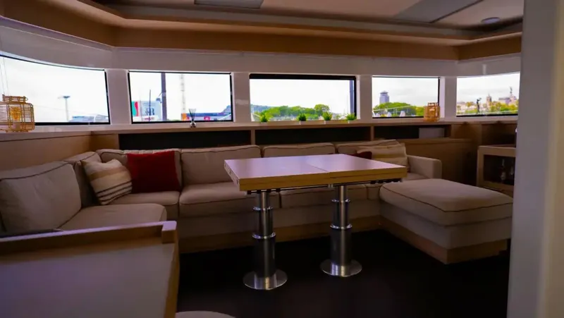 Jdmontt Yacht Photos Pics Luxurious interior of 2024 Lagoon 55 yacht with spacious seating and panoramic windows.