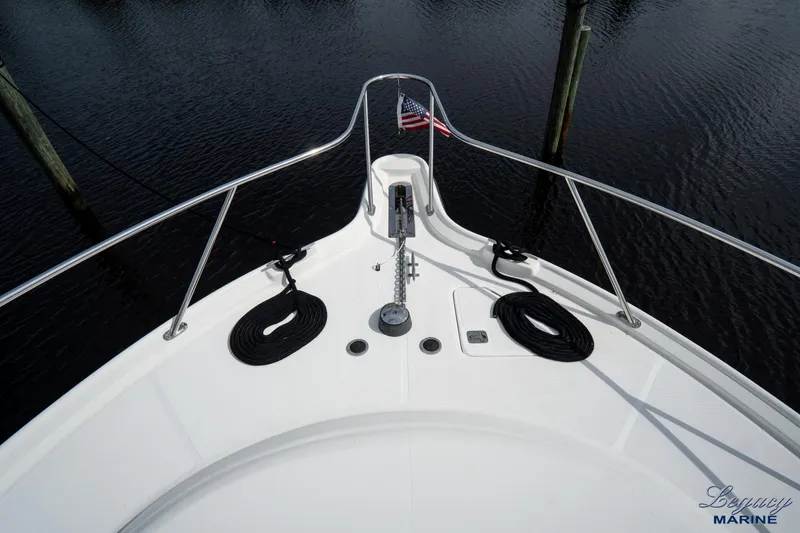 Legacy Yacht Photos Pics Bow of 2003 Tiara Yachts 4200 Open with American flag and mooring ropes.