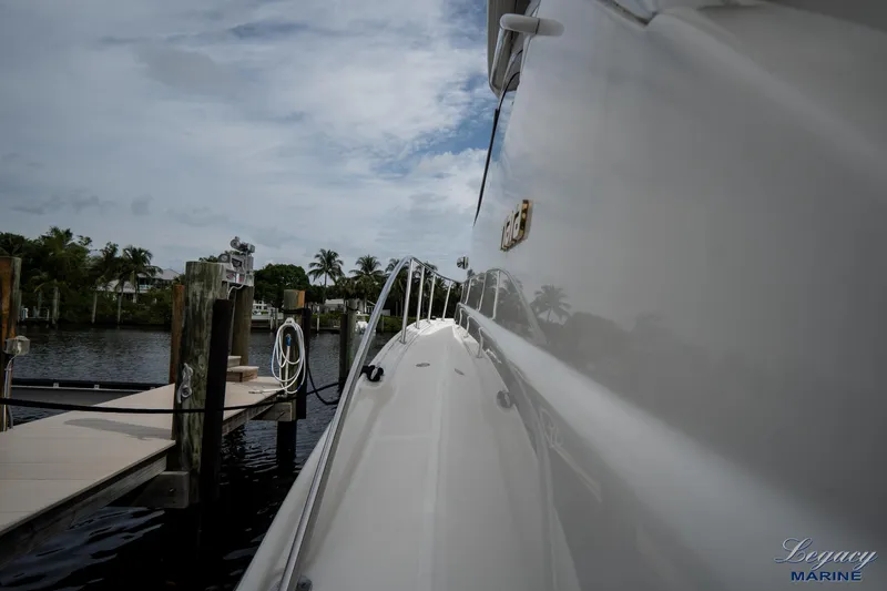 Legacy Yacht Photos Pics 2003 Tiara Yachts 4200 Open docked, side view with water and palm trees.