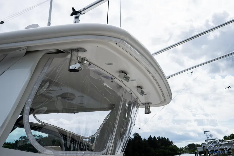 Legacy Yacht Photos Pics 2003 Tiara Yachts 4200 Open boat, showcasing sleek design and clear canopy under a cloudy sky.