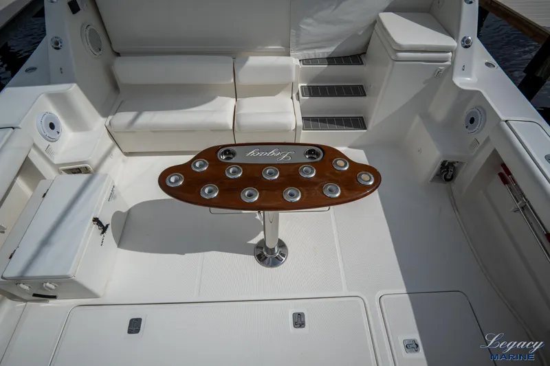 Legacy Yacht Photos Pics 2003 Tiara Yachts 4200 Open cockpit with seating and wooden table.