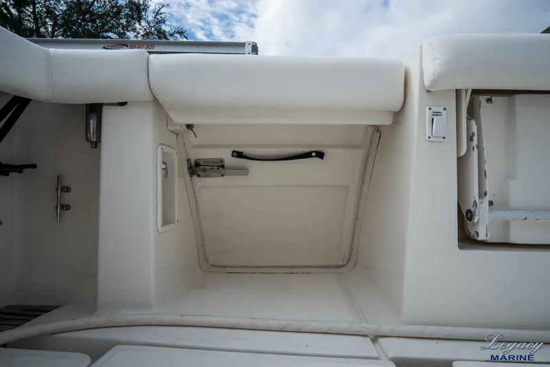 Legacy Yacht Photos Pics 2003 Tiara Yachts 4200 Open, interior storage compartment, white upholstery, marine setting.
