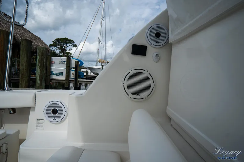 Legacy Yacht Photos Pics 2003 Tiara Yachts 4200 Open interior with speakers and seating, docked at marina.