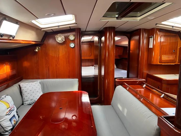 Southern Sky Yacht Photos Pics Interior of 1991 Beneteau Oceanis 510 sailboat with wood finish and cozy seating area.