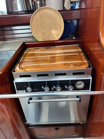 Southern Sky Yacht Photos Pics Stove in 1991 Beneteau Oceanis 510 yacht kitchen with wooden cover.