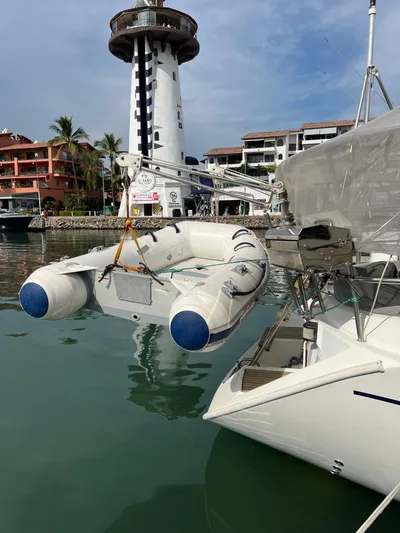 Southern Sky Yacht Photos Pics Beneteau Oceanis 510 sailboat docked near a lighthouse, with inflatable dinghy, 1991 model.