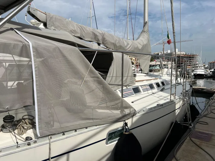 Southern Sky Yacht Photos Pics 1991 Beneteau Oceanis 510 sailboat docked in marina, side view with canopy.