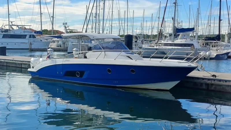 Jessica Yacht Photos Pics 2009 Sessa Marine Key Largo 36 boat docked in a marina, reflecting on calm water.