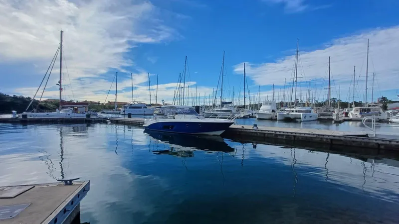 Jessica Yacht Photos Pics 2009 Sessa Marine Key Largo 36 docked in a marina with sailboats and blue sky.