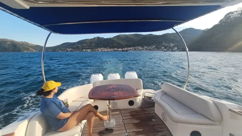 Jessica Yacht Photos Pics Woman relaxing on a 2009 Sessa Marine Key Largo 36 boat, scenic coastal view.