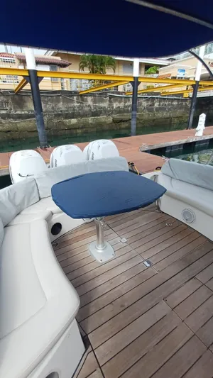 Jessica Yacht Photos Pics 2009 Sessa Marine Key Largo 36 boat with seating and table, docked by the water.