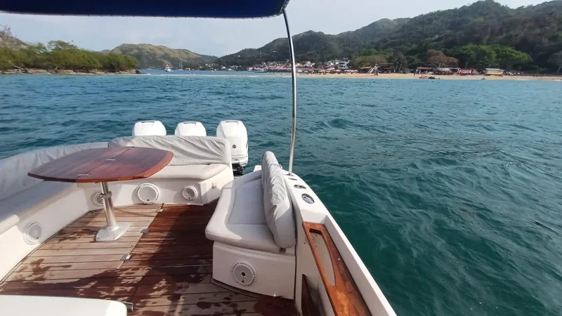 Jessica Yacht Photos Pics 2009 Sessa Marine Key Largo 36 yacht on serene waters near a scenic coastline.