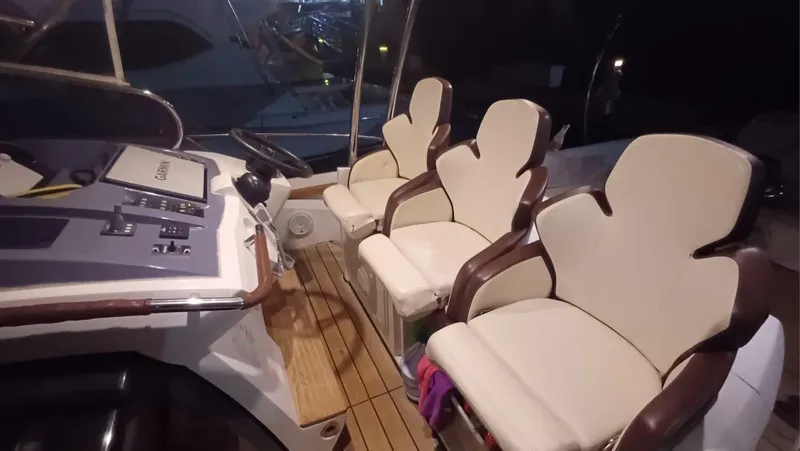 Jessica Yacht Photos Pics 2009 Sessa Marine Key Largo 36 cockpit with three beige seats and control panel.