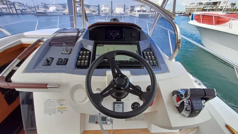 Jessica Yacht Photos Pics Cockpit view of 2009 Sessa Marine Key Largo 36, featuring steering wheel and control panel.