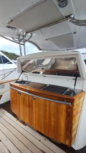 Jessica Yacht Photos Pics Outdoor kitchen on 2009 Sessa Marine Key Largo 36 yacht with wooden cabinetry.