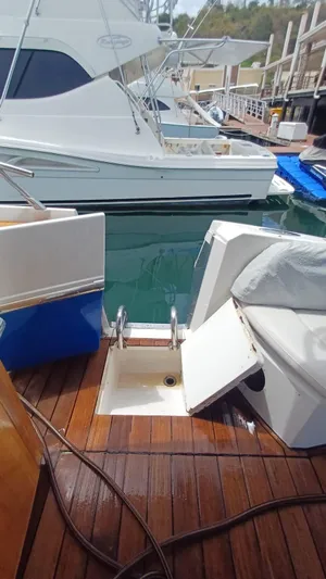 Jessica Yacht Photos Pics 2009 Sessa Marine Key Largo 36 docked, featuring wooden deck and seating area.