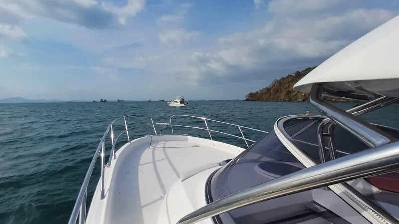 Jessica Yacht Photos Pics 2009 Sessa Marine Key Largo 36 cruising on open sea near rocky coastline.