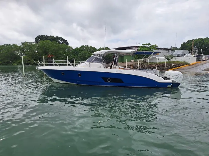 Jessica Yacht Photos Pics 2009 Sessa Marine Key Largo 36 boat docked on calm water, overcast sky.
