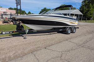 2006 Tahoe Q6 Sport boat on trailer, parked on roadside.