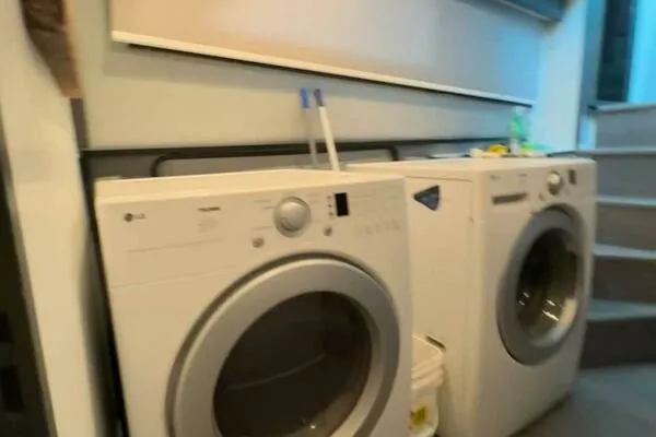 Still Pure Joy Yacht Photos Pics Laundry area on a 1987 Hatteras 63 yacht with washer and dryer.