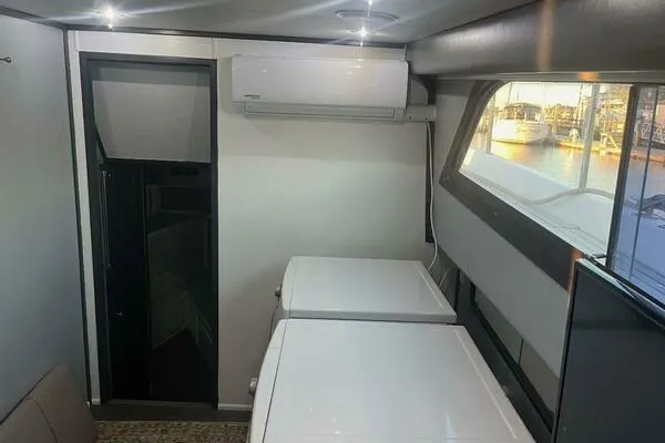 Still Pure Joy Yacht Photos Pics Interior of 1987 Hatteras 63 yacht with washer, dryer, and window view.