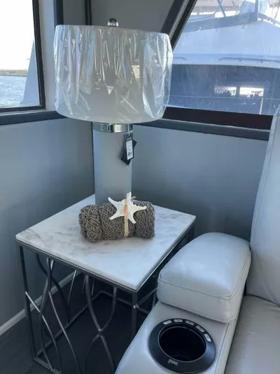 Still Pure Joy Yacht Photos Pics Luxurious interior of 1987 Hatteras 63 yacht with elegant lamp and decor.