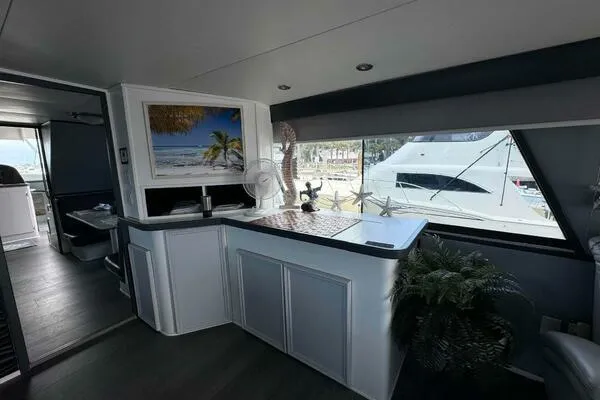 Still Pure Joy Yacht Photos Pics Luxurious interior of 1987 Hatteras 63 yacht with elegant decor and large windows.