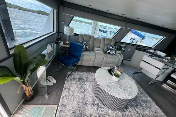 Still Pure Joy Yacht Photos Pics Luxurious interior of 1987 Hatteras 63 yacht with modern furnishings and scenic water views.