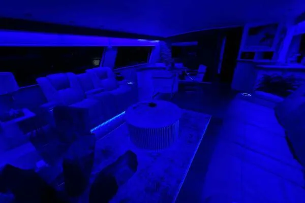 Still Pure Joy Yacht Photos Pics Luxurious interior of a 1987 Hatteras 63 yacht with blue ambient lighting.