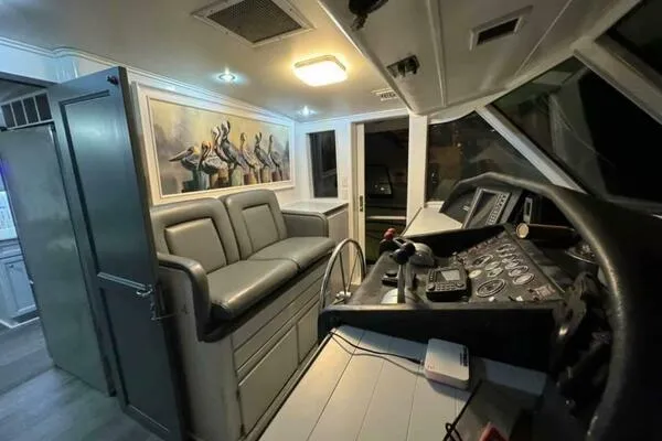 Still Pure Joy Yacht Photos Pics 1987 Hatteras 63 yacht interior with helm, seating, and artwork.