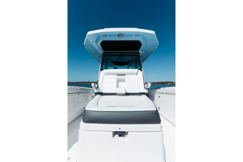 Lickety-split Yacht Photos Pics 2021 Blackfin 332 CC boat with sleek seating and canopy on open water.