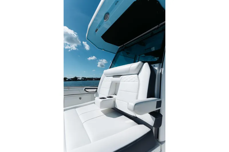 Lickety-split Yacht Photos Pics Luxurious seating on 2021 Blackfin 332 CC boat under clear blue sky.