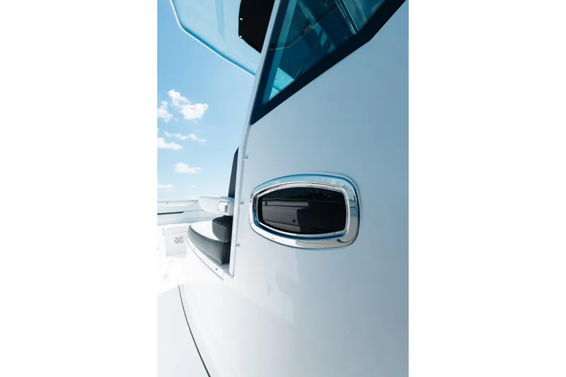 Lickety-split Yacht Photos Pics 2021 Blackfin 332 CC boat detail with sleek design and chrome accents under blue sky.