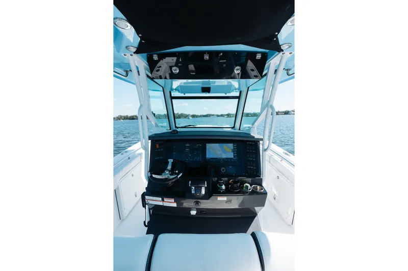 Lickety-split Yacht Photos Pics 2021 Blackfin 332 CC boat helm with advanced navigation system on open water.