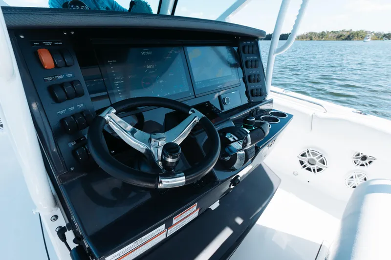 Lickety-split Yacht Photos Pics 2021 Blackfin 332 CC boat dashboard with steering wheel and navigation controls.