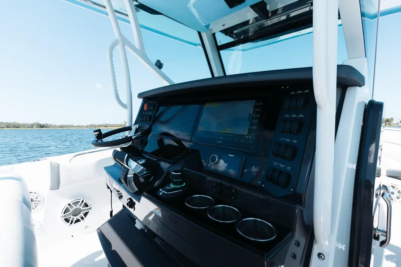 Lickety-split Yacht Photos Pics 2021 Blackfin 332 CC boat dashboard with advanced navigation system on open water.