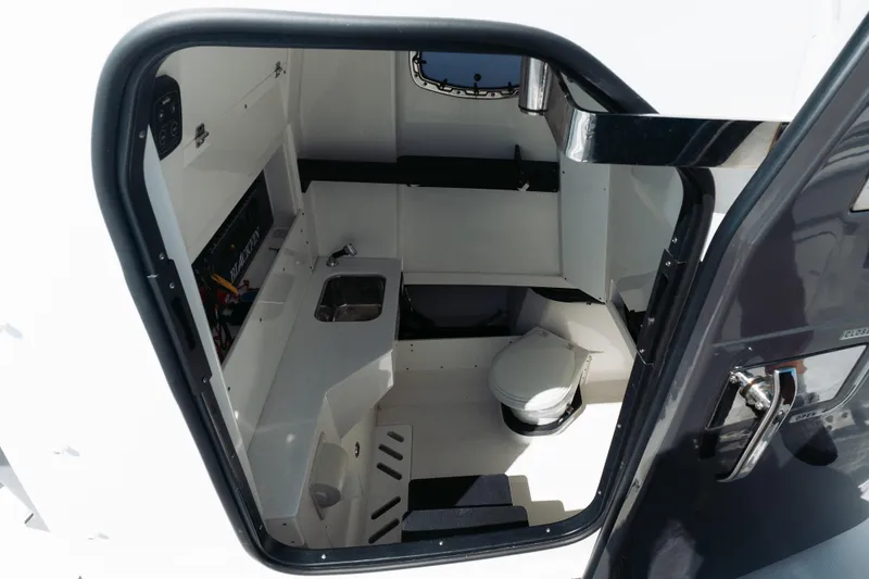 Lickety-split Yacht Photos Pics Interior view of 2021 Blackfin 332 CC boat cabin with sink and toilet.