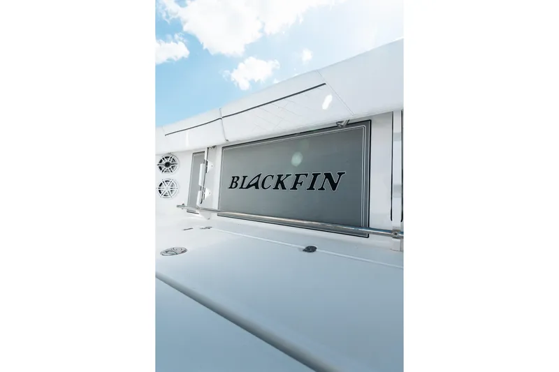 Lickety-split Yacht Photos Pics 2021 Blackfin 332 CC boat with sleek design and logo under blue sky.