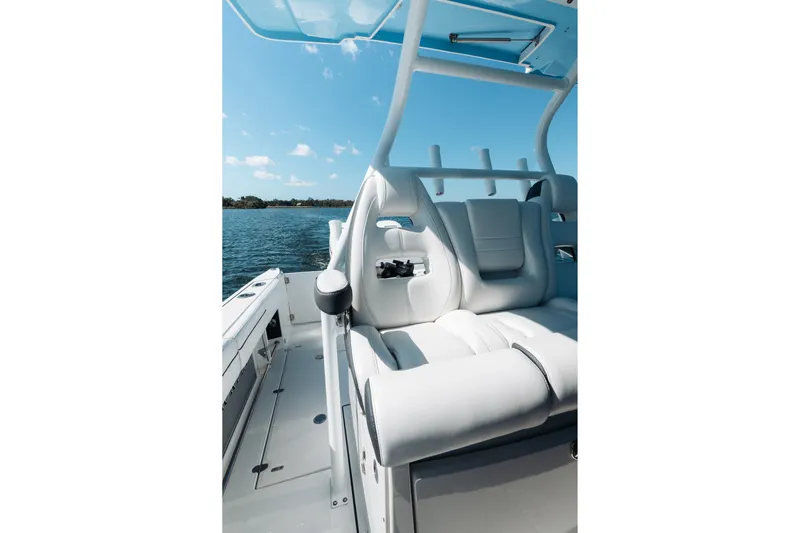 Lickety-split Yacht Photos Pics 2021 Blackfin 332 CC boat interior with white seating and ocean view.