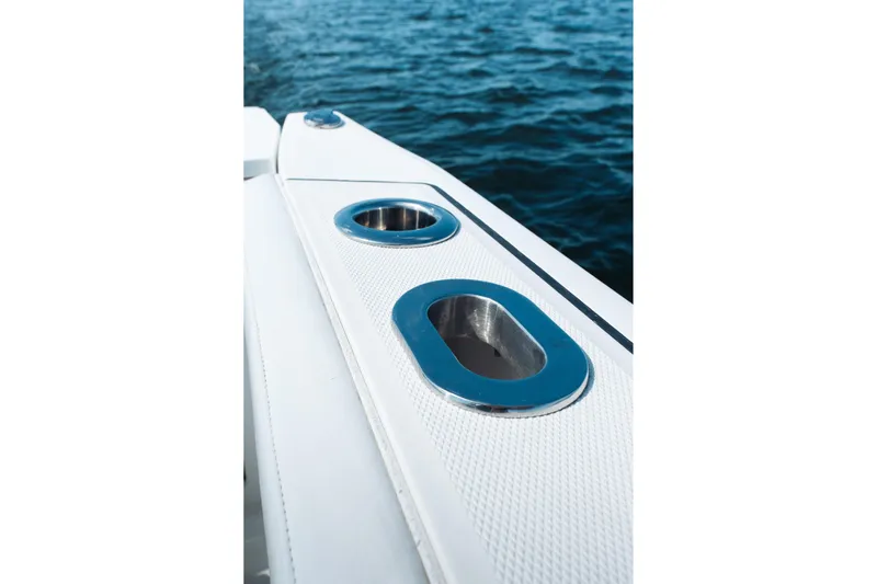 Lickety-split Yacht Photos Pics 2021 Blackfin 332 CC boat detail with cup holders, ocean background.