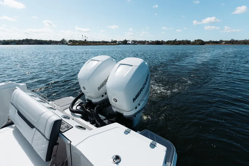 Lickety-split Yacht Photos Pics 2021 Blackfin 332 CC boat with dual Mercury engines on a calm lake.