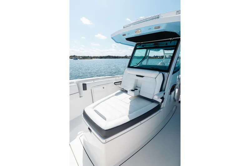 Lickety-split Yacht Photos Pics 2021 Blackfin 332 CC boat interior with white seating, cup holders, and ocean view.