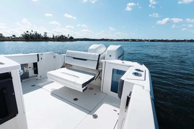 Lickety-split Yacht Photos Pics 2021 Blackfin 332 CC boat with seating, on calm water under a clear sky.