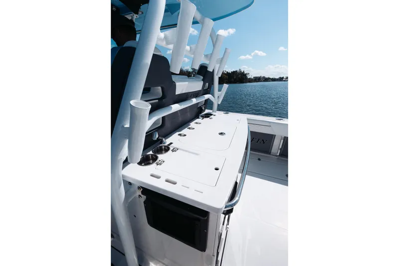 Lickety-split Yacht Photos Pics 2021 Blackfin 332 CC boat interior with rod holders and ocean view.