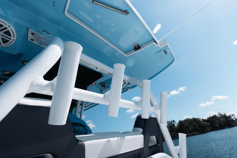 Lickety-split Yacht Photos Pics 2021 Blackfin 332 CC boat with rod holders, under clear blue sky.