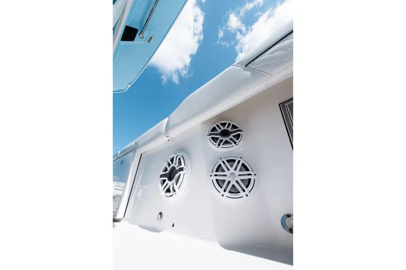 Lickety-split Yacht Photos Pics 2021 Blackfin 332 CC boat speakers against a clear blue sky.